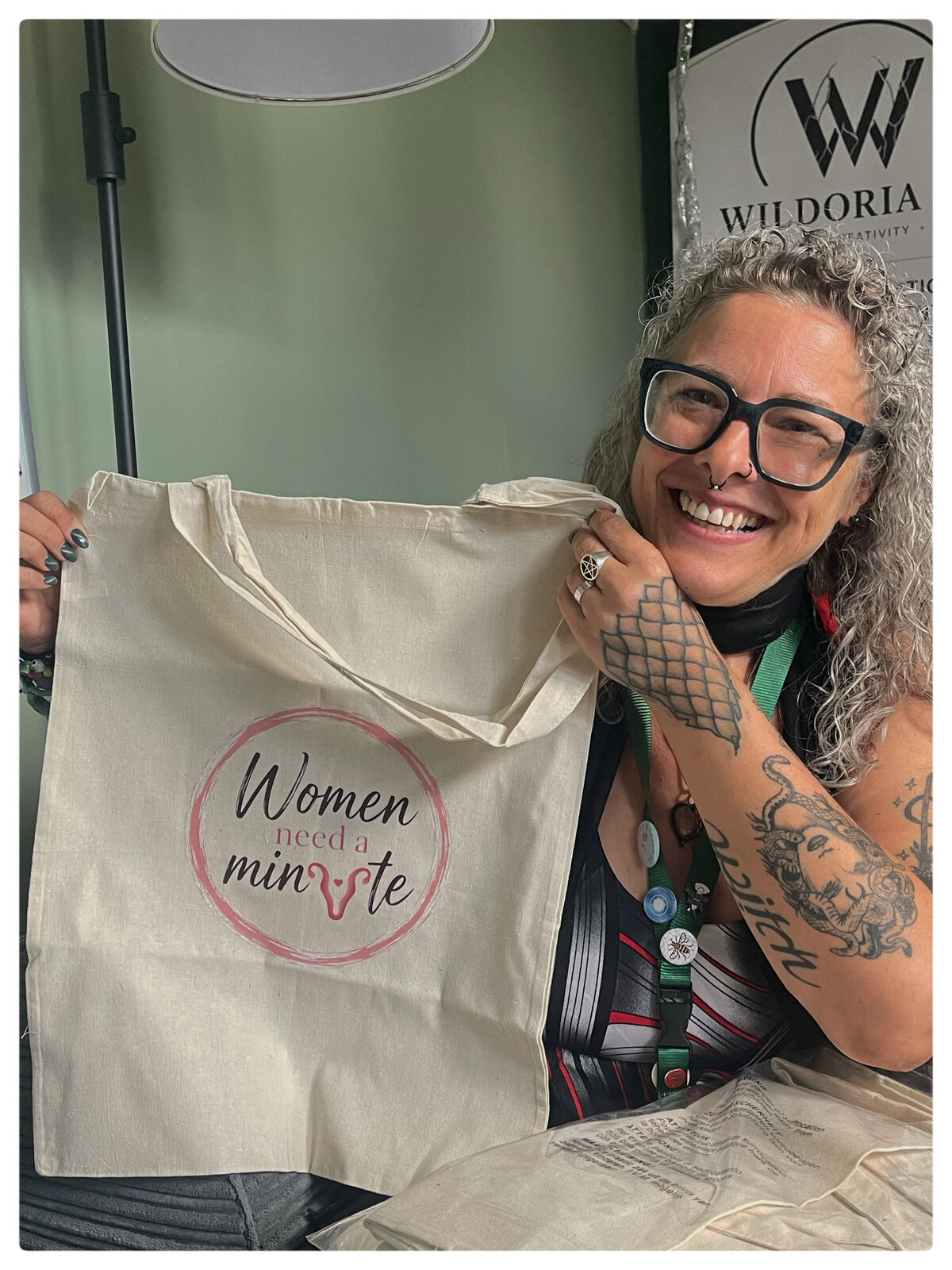 Elise from Wildoria CIC holding a custom printed tote bag — one happy TCCN customer