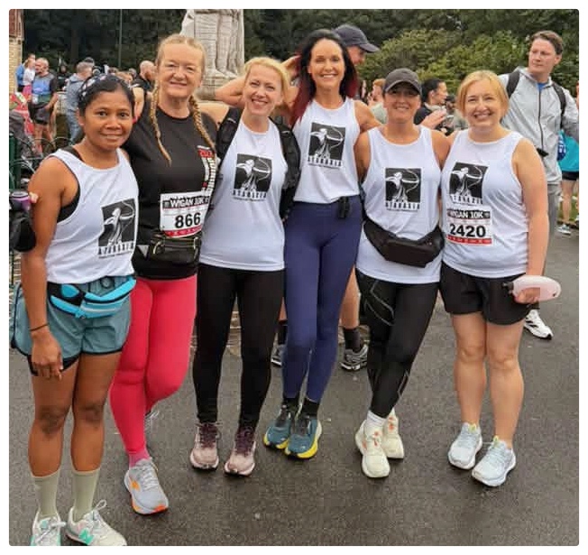 Ataraxia CIC fundraisers running for Joining Jack at the Wigan 10K 2026 in Mesnes Park — participants taking part in the Wigan 10K charity run, race day tops printed by TCCN in Wigan